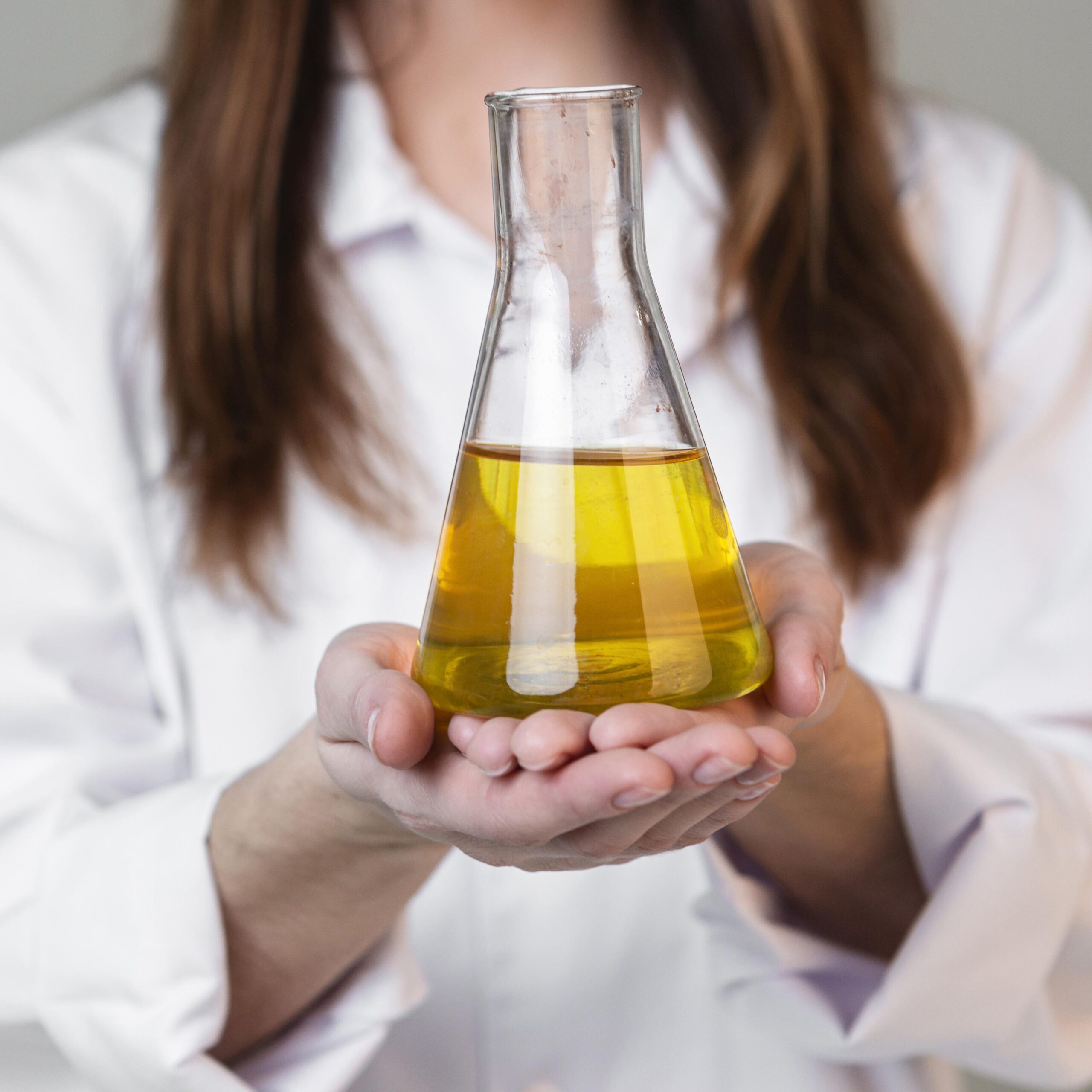 front view female scientist holding test tube